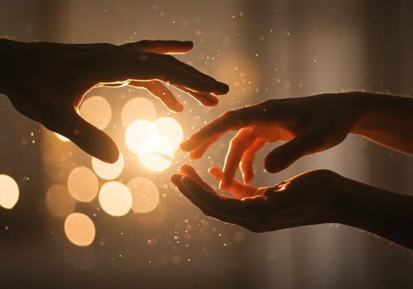 Hands gently reconnecting amidst abstract light, symbolizing healing